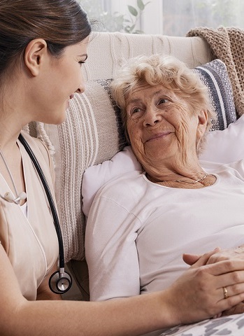 Nurse comforting hospice patient