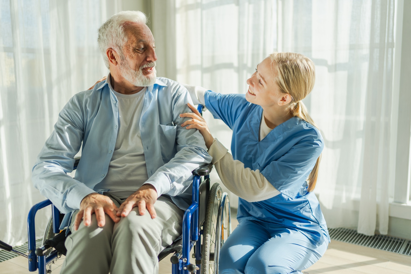 Caregiver helping patient in wheelchair