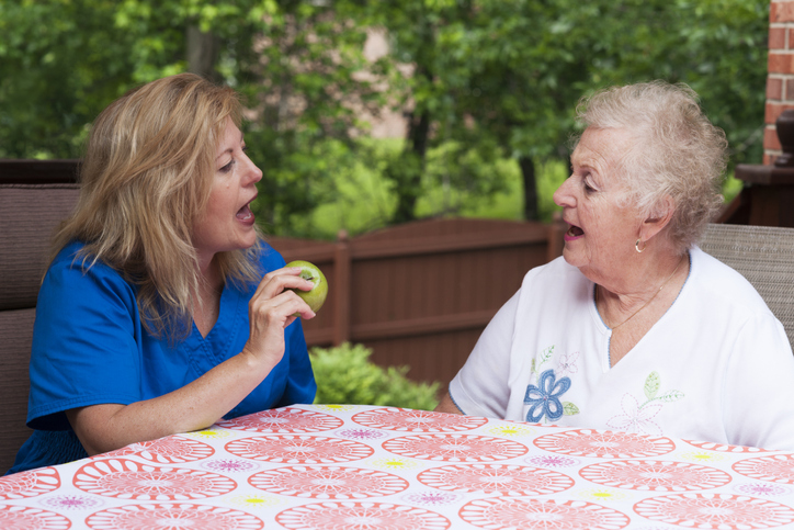two women talking at a table
