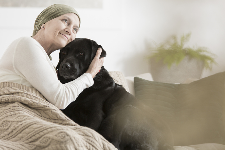 woman in hospice hugging dog